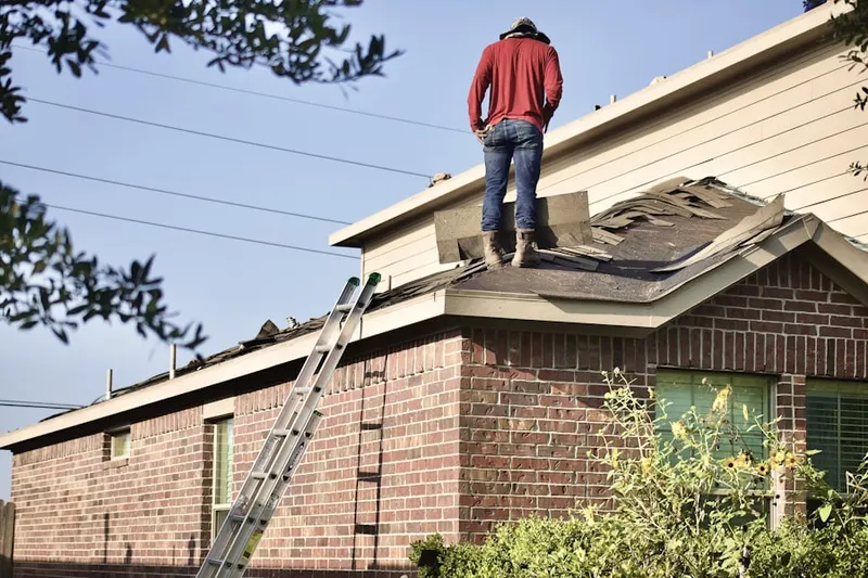 Professional roofer working on a residential roof in Kinston
